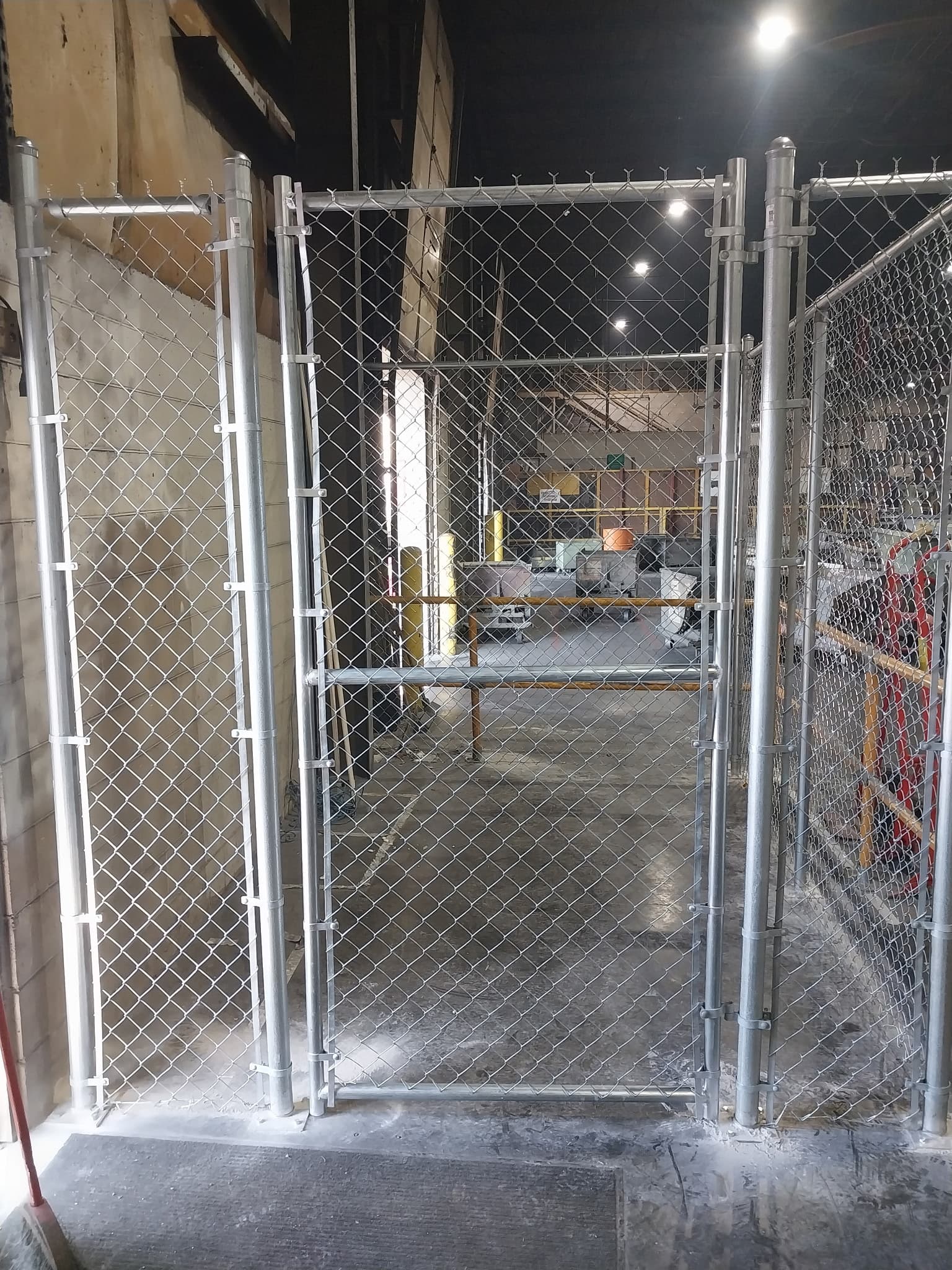 Chain-link fence with concrete post installation